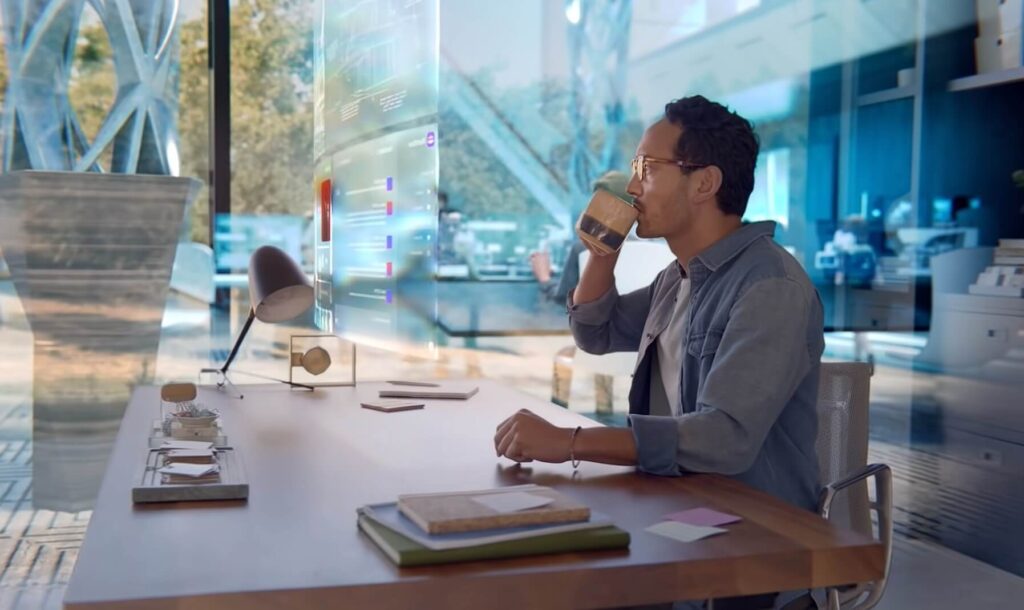 Man with AR Glasses working with digital monitors